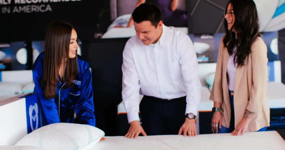Snooze Sleep Coaches fitting a customer on a mattress